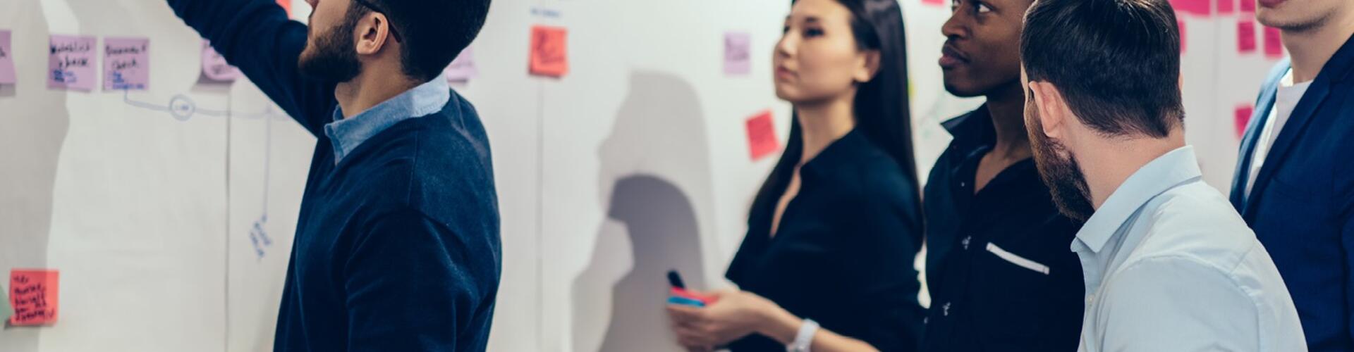 team of people working at a whiteboard